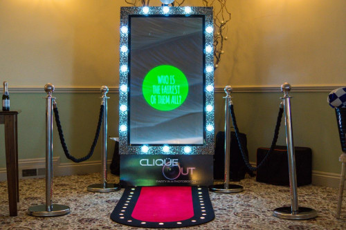 Selfie mirror photo booth with lights, red carpet and barriers